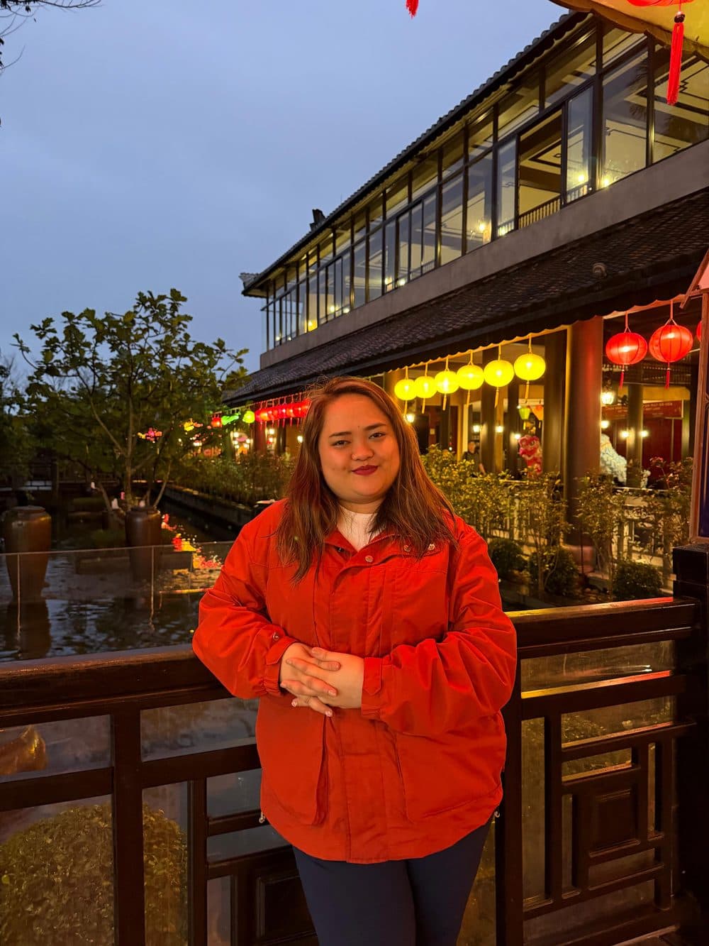 Alyssa at dusk under warm festival lanterns