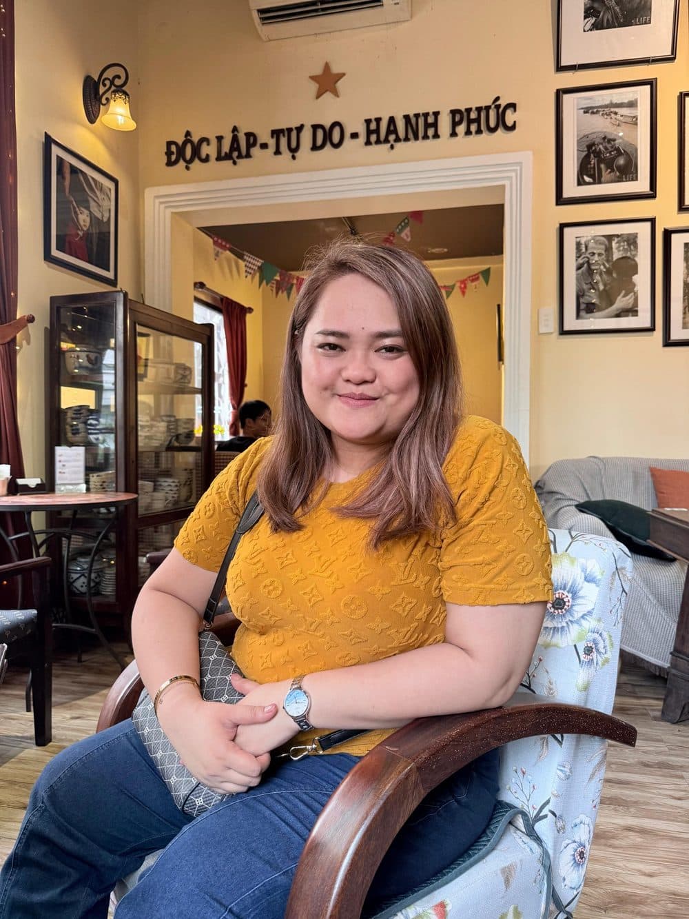 Alyssa Marie Hassan smiling in warm cafe light